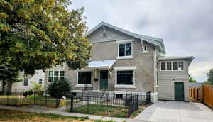 View of front of house featuring a fenced front yard and brick siding