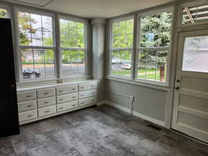 Unfurnished sunroom featuring plenty of natural light