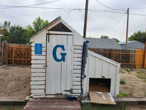 View of outdoor structure featuring a fenced backyard