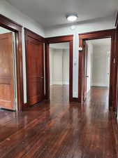 Hallway featuring dark wood-type flooring