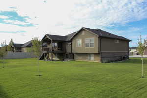 Rear view of property with stairs, stucco siding, a deck, brick siding, and a patio area