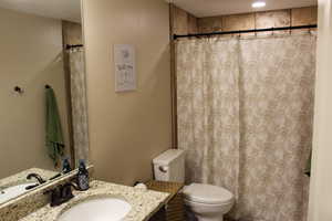 Full bathroom with vanity and toilet