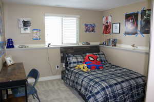 Bedroom featuring carpet flooring and baseboards