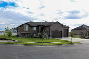 French provincial home with brick siding, driveway, an attached garage, and stucco siding