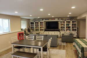 Dining area with recessed lighting and light wood finished floors