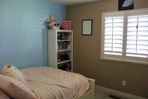Bedroom featuring carpet floors and baseboards