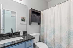 Full bath with vanity and a shower with shower curtain