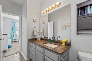 Bathroom with vanity and light wood-type flooring