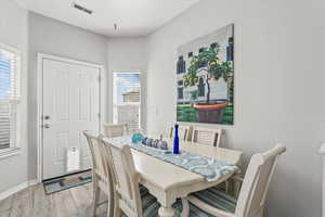 Dining room featuring light wood finished floors and baseboards