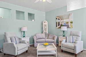 Living room with carpet floors and ceiling fan