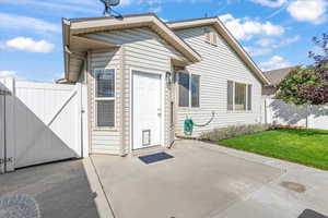 Property entrance featuring a gate and a patio area