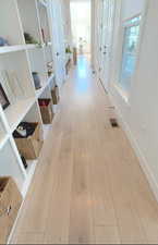 Corridor featuring light wood-style floors
