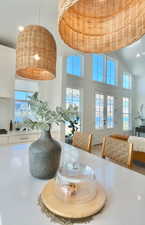 Dining room with french doors, a high ceiling, and recessed lighting