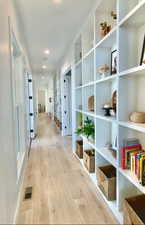 Hallway featuring light wood-style flooring and recessed lighting