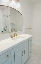 Full bath featuring vanity, a shower stall, and light tile patterned floors