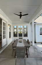 Sunroom with unfinished concrete flooring