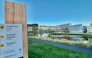 Surrounding community featuring a water view and a lawn