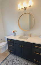 Half bath with vanity and toilet