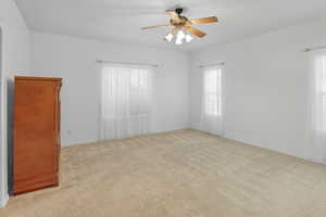 Spare room with light carpet and ceiling fan