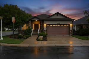 Craftsman inspired home featuring driveway, stone siding, and a garage