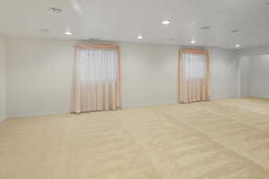 Room featuring recessed lighting and light carpet