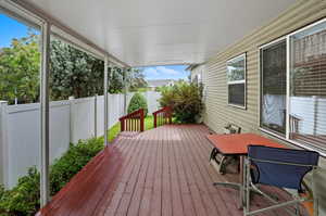 Wooden deck featuring a fenced backyard