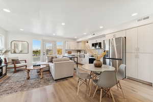 Dining room with light wood-type flooring and recessed lighting