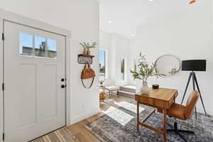 Foyer entrance with light wood-style flooring and recessed lighting