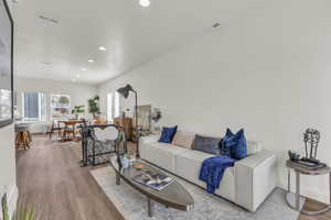 Living room featuring wood finished floors and recessed lighting