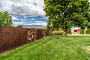 Fenced backyard with a mountain view