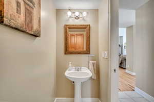 Half bathroom with light tile patterned flooring and baseboards