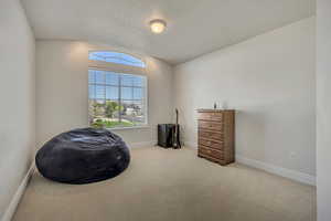 Front upstairs bedroom featuring carpet and baseboards