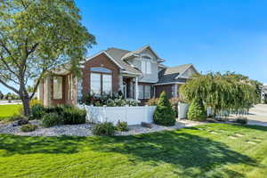 View of front of property with brick siding and roof with shingles