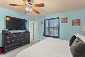 Bedroom featuring light carpet and ceiling fan