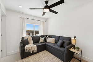 Living area with carpet flooring, recessed lighting, and ceiling fan