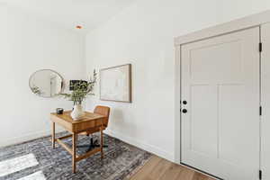 Office space with wood finished floors and baseboards