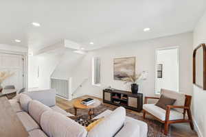Living room featuring wood finished floors and recessed lighting