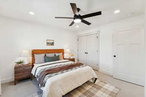 Bedroom with light colored carpet, recessed lighting, a ceiling fan, and a closet