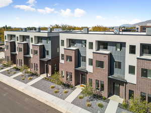 Modern home featuring board and batten siding and brick siding
