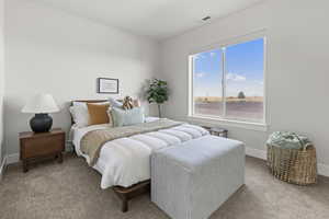 Bedroom featuring carpet and baseboards