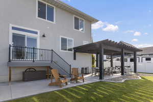 Back of property featuring a patio, a pergola, stucco siding, and stairs