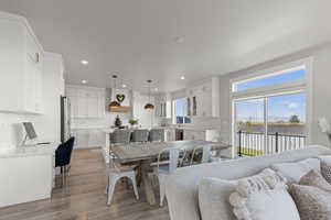 Dining space with light wood-type flooring and recessed lighting