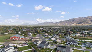 Aerial view of property's location featuring nearby suburban area and mountains