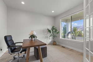 Office area with light wood-style flooring, recessed lighting, and a mountain view