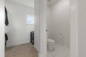 Bathroom featuring light marble finish flooring and radiator heating unit