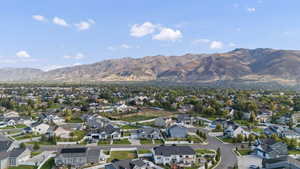Aerial overview of property's location featuring nearby suburban area and a mountain backdrop