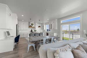 Dining area featuring healthy amount of natural light, light wood-style flooring, and recessed lighting