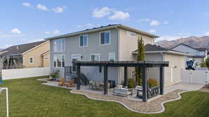 Back of property with a patio area, stucco siding, a fenced backyard, a gate, and an outdoor hangout area