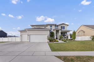 Prairie-style house featuring covered porch, driveway, and a garage