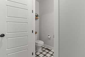 Bathroom with toilet and tile patterned flooring